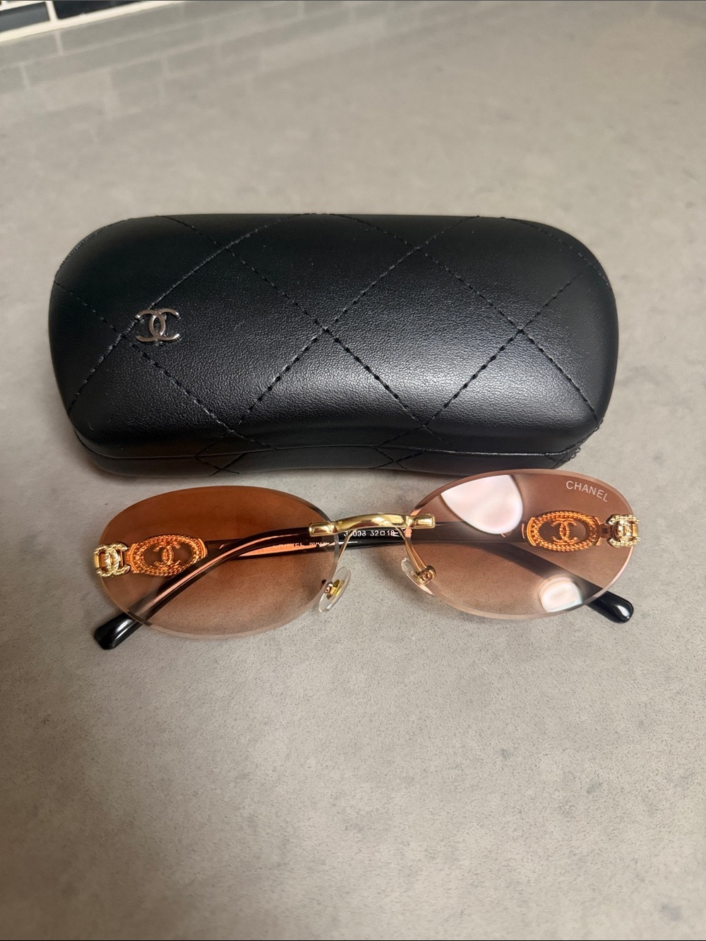 CHANEL Rimless Oval Sunglasses in Brown with Gold Accents